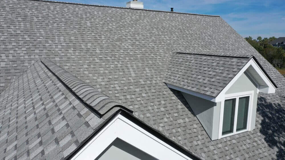 Gray roof shingles providing weather protection and aesthetic appeal to a residential building.