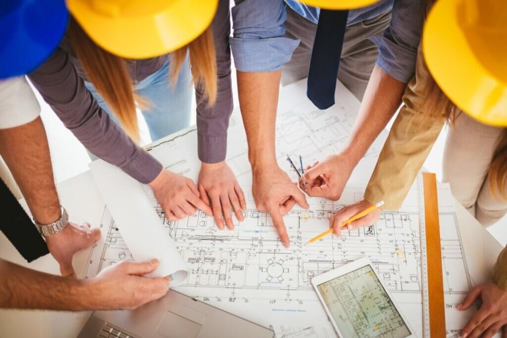 A group of engineers and contractors around a construction project