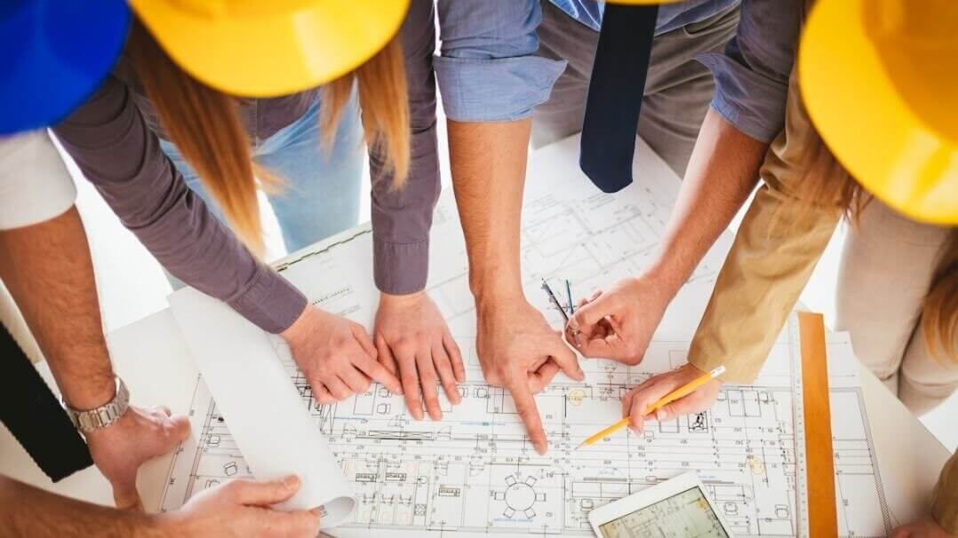 A group of engineers and contractors around a construction project.