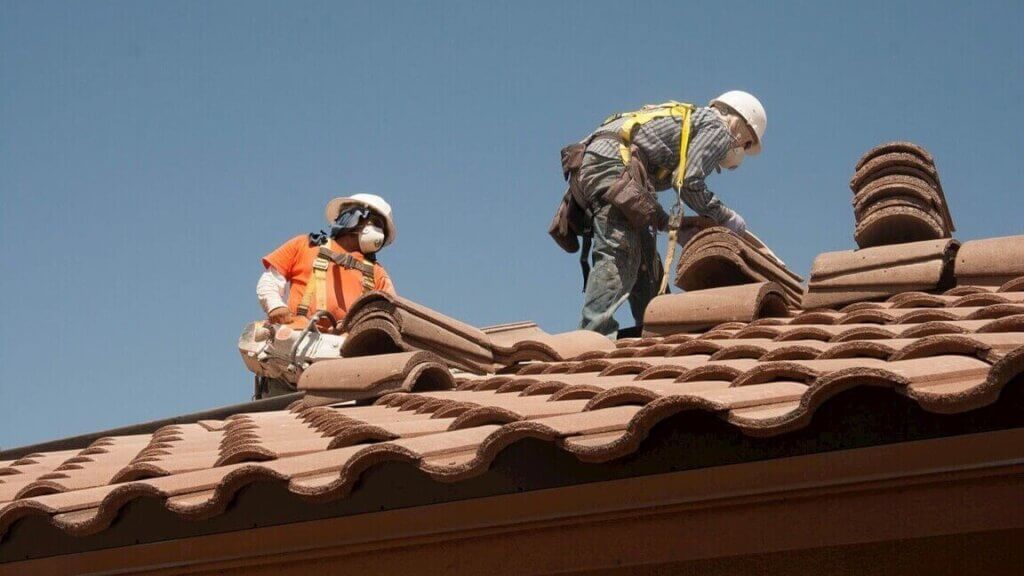 Two men engaged in roofing services.