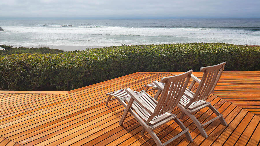 wood deck with two beach chairs, a