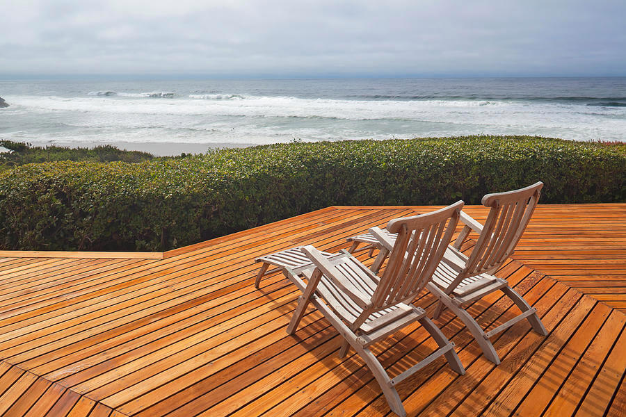 wood deck with two beach chairs, a 