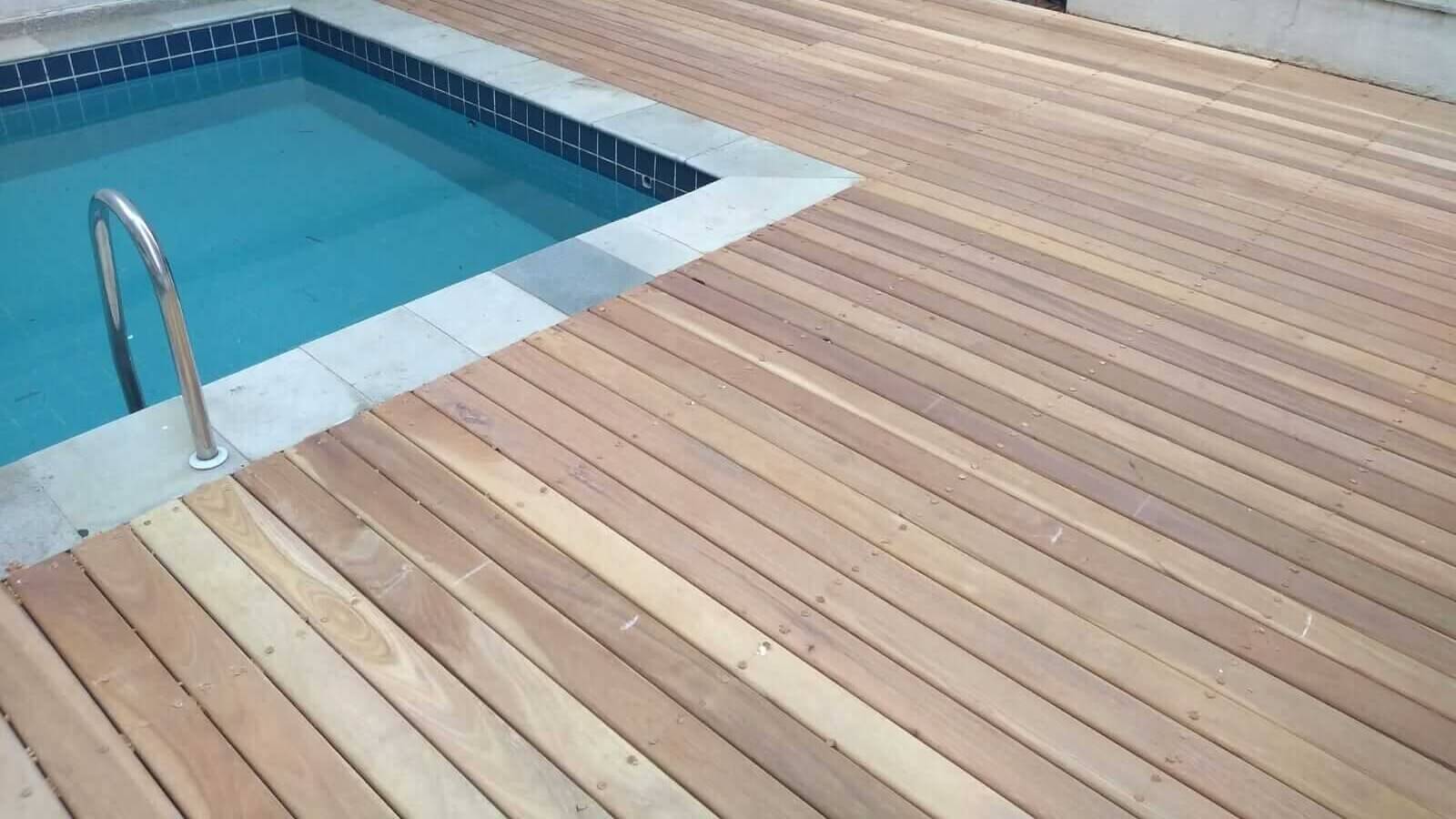 wood deck with a pool on the left side.