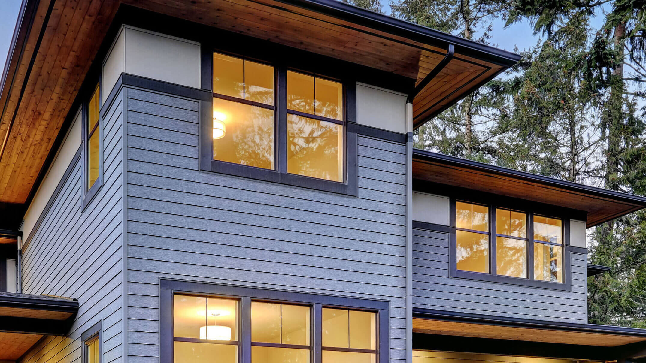 fornt of  house with a loght blue siding and three windows.